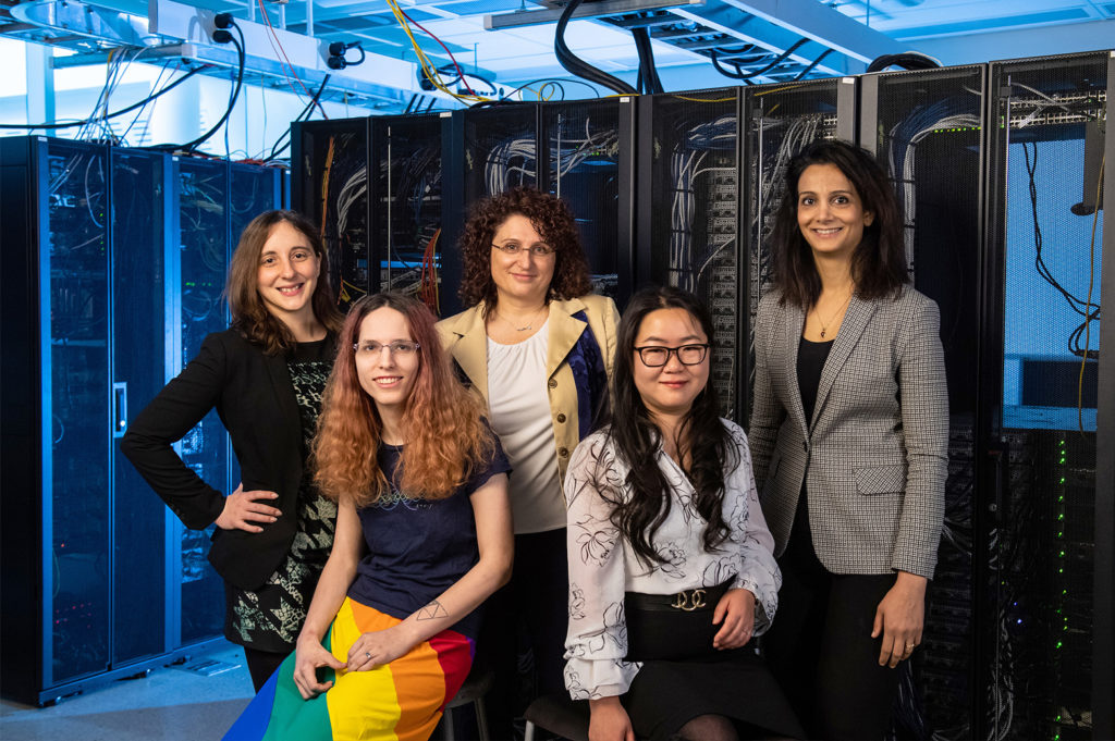 Five women faculty in a server room