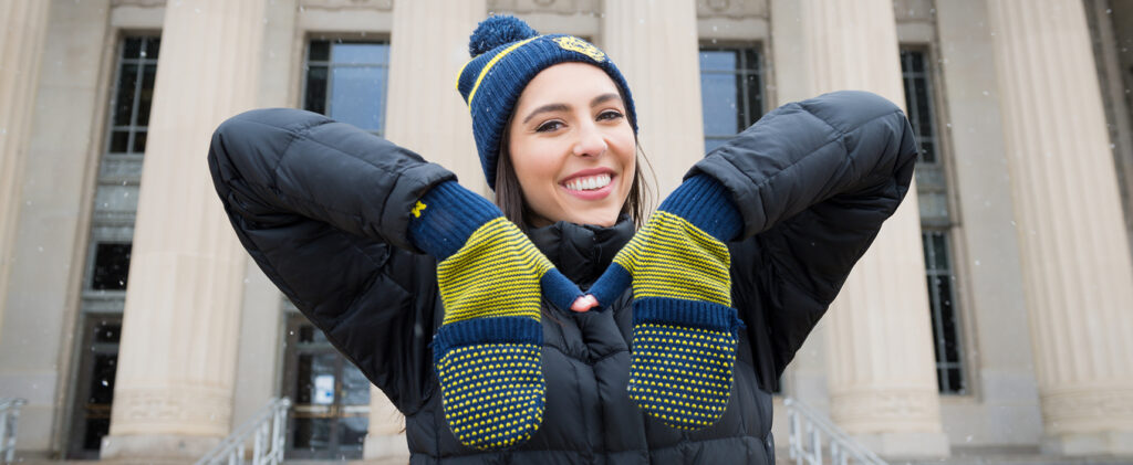 Student with U-M gloves in M-shape