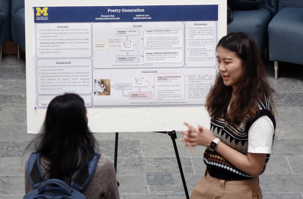 Two students discuss  a poster at a poster session